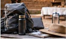 Retreat packing essentials including backpack, water bottle, hat, and journal