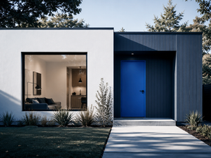 Small modern detached backyard ADU with a clean facade, large window, and simple entry door in daylight.