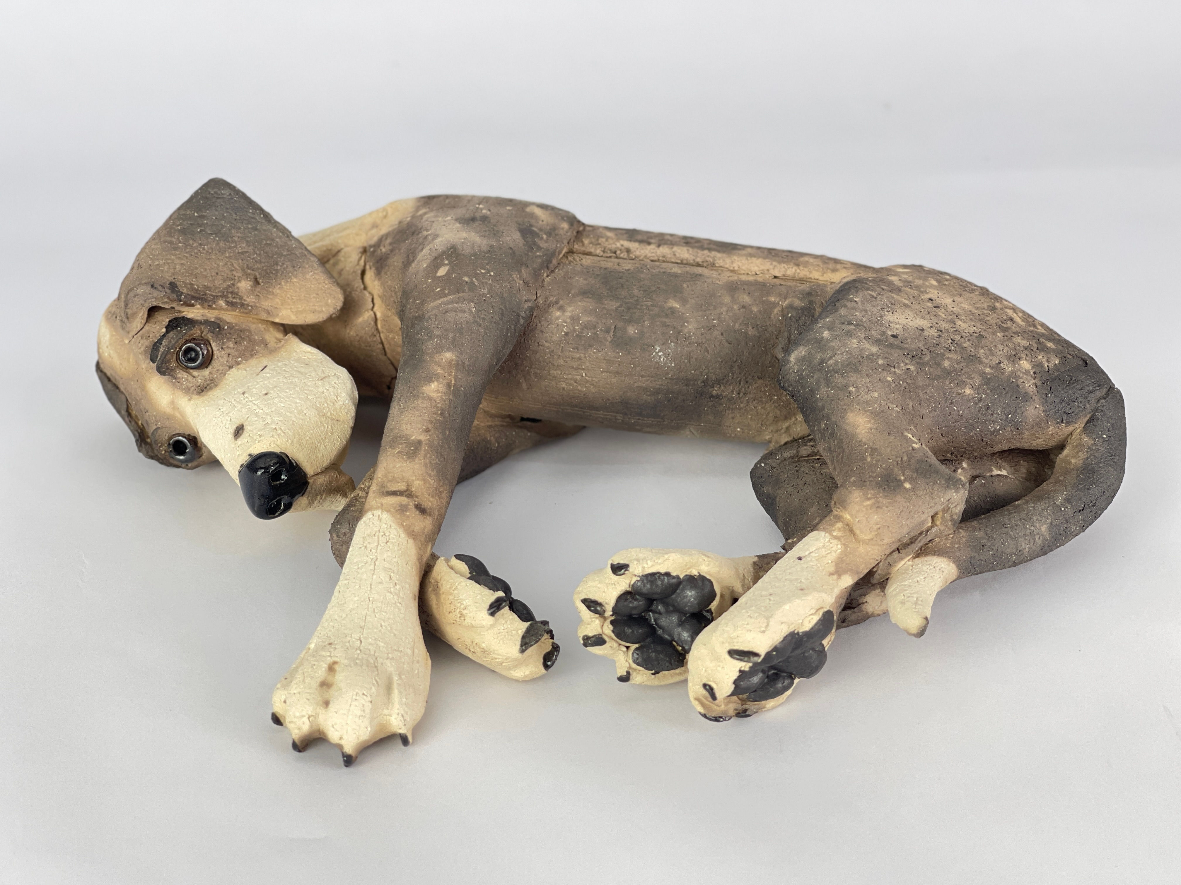 Laying patchy ceramic dog