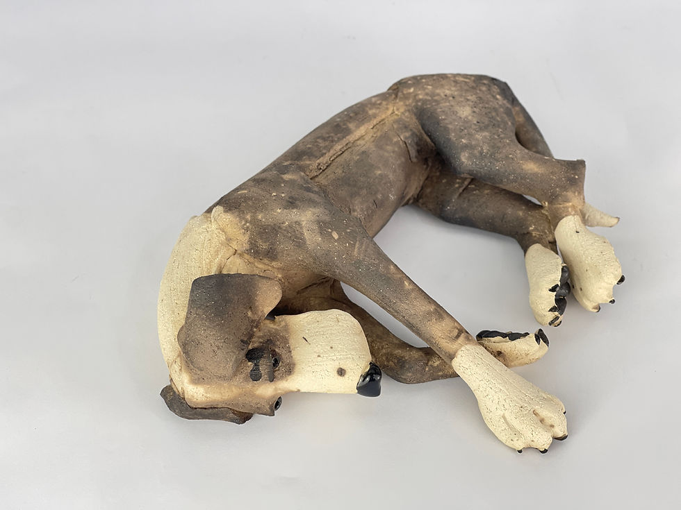 Thumbnail: Laying patchy ceramic dog