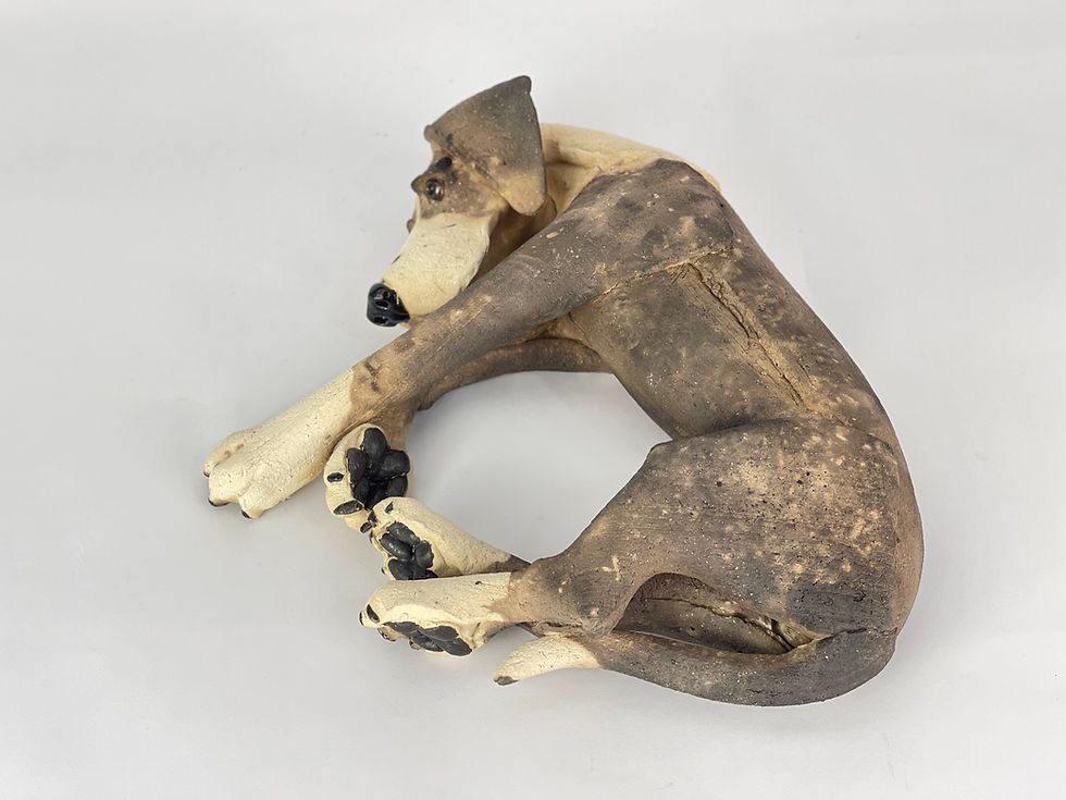 Thumbnail: Laying patchy ceramic dog