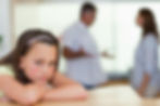 Sad girl with her fighting parents behind her