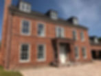 large house with coloured cast stonework