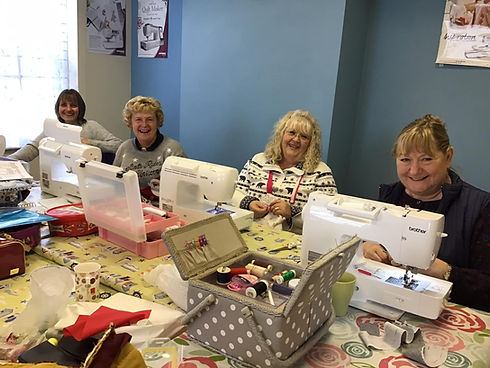students sat at sewing machines
