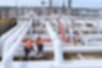 large pipes and workers