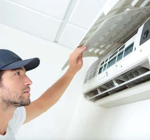 Technician looking at aircon system