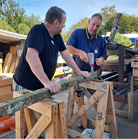 Jan working with a visitor to recycle some old wood