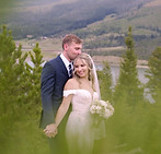 Newly wed couple posing for pictures at Sapphire Point in Dillon, Colorado