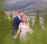 Newly wed couple posing for pictures at Sapphire Point in Dillon, Colorado