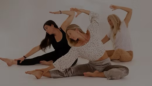 Three women practising yoga