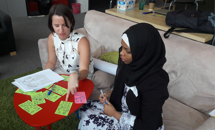 Two women looking at notes