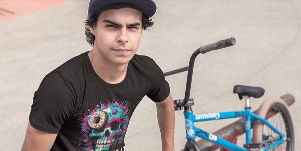 Dude on a bmx bike near a beach wearing the OG Team Donut Factory shirt