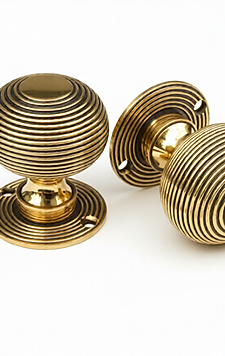 Beehive Brass Door Knob Set Shoing here in Antique Brass Finish on White Background