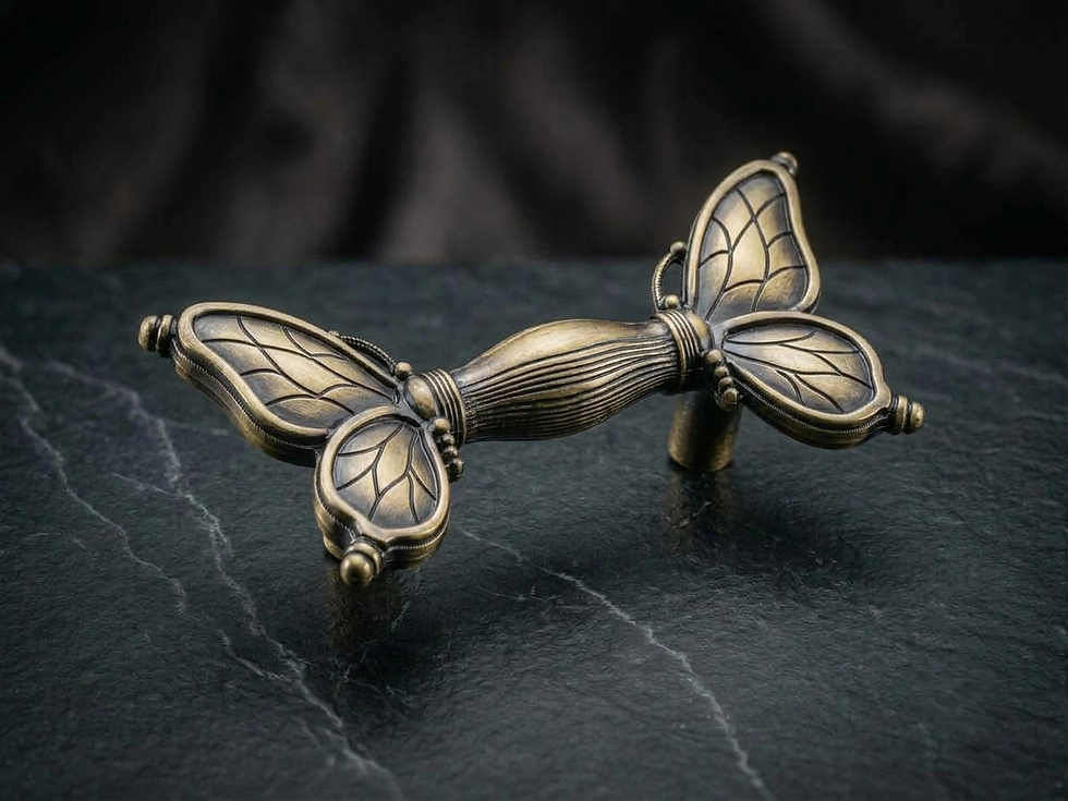 Antique brass butterfly filigree cabinet pull handle on dark stone surface by Craftacks