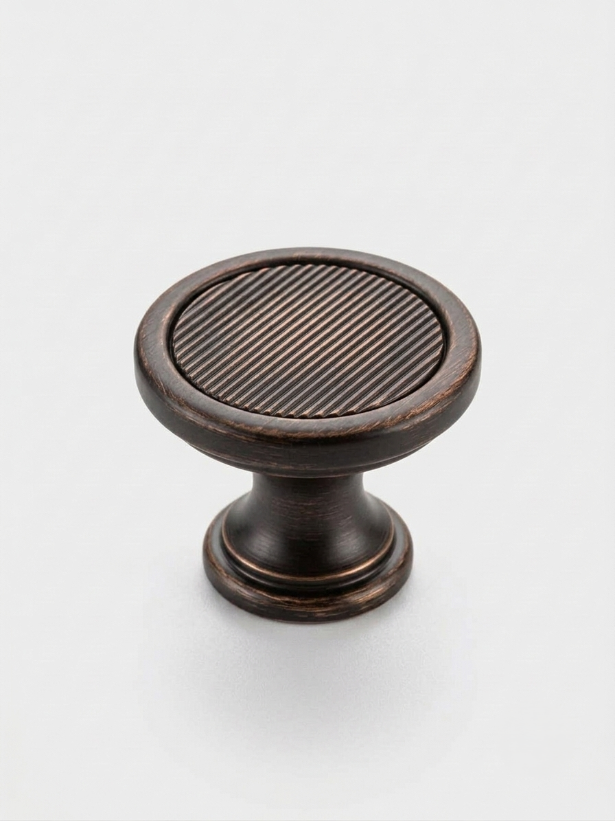 Thumbnail: Craftacks modern ribbed round cabinet knob with an oil rubbed bronze finish displayed on a neutral background