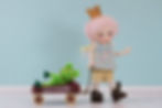 Close-up view of Puppy the princess doll in a pastel dress with unicorn patterns