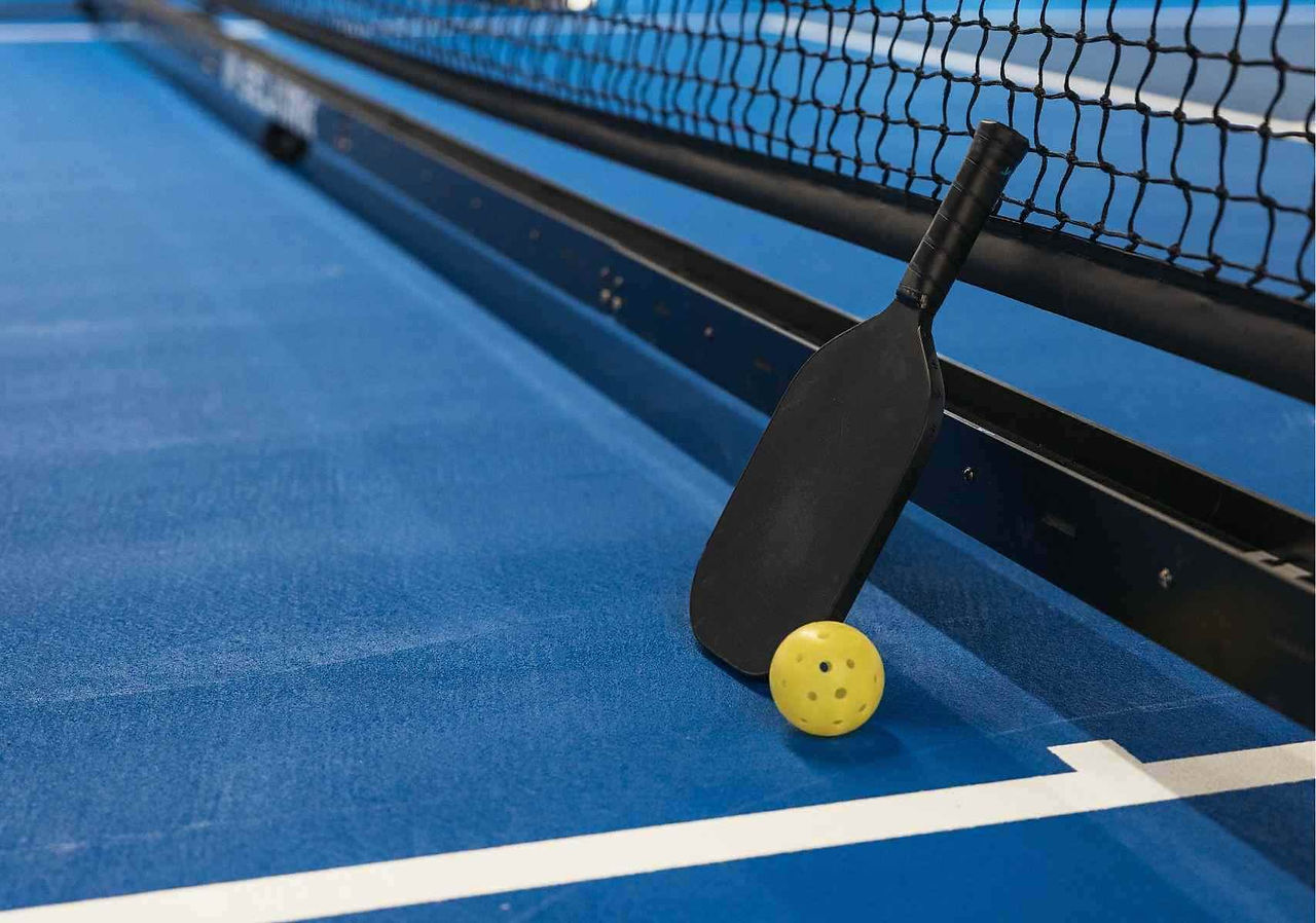 paddle and ball on a blue court