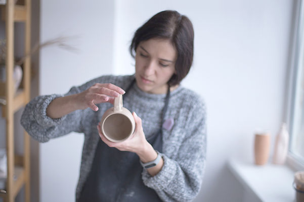 Female Potter Making Mug