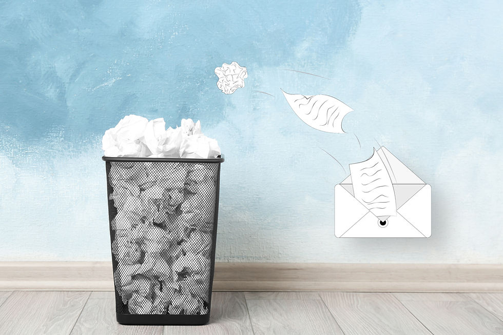 Paper crumpled into a trash bin, with sheets flying toward an open envelope on a blue wall background.