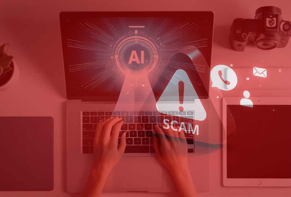 Hands typing on a laptop with "AI" on screen, red alert saying "SCAM," icons of messages and calls, camera and plant nearby.