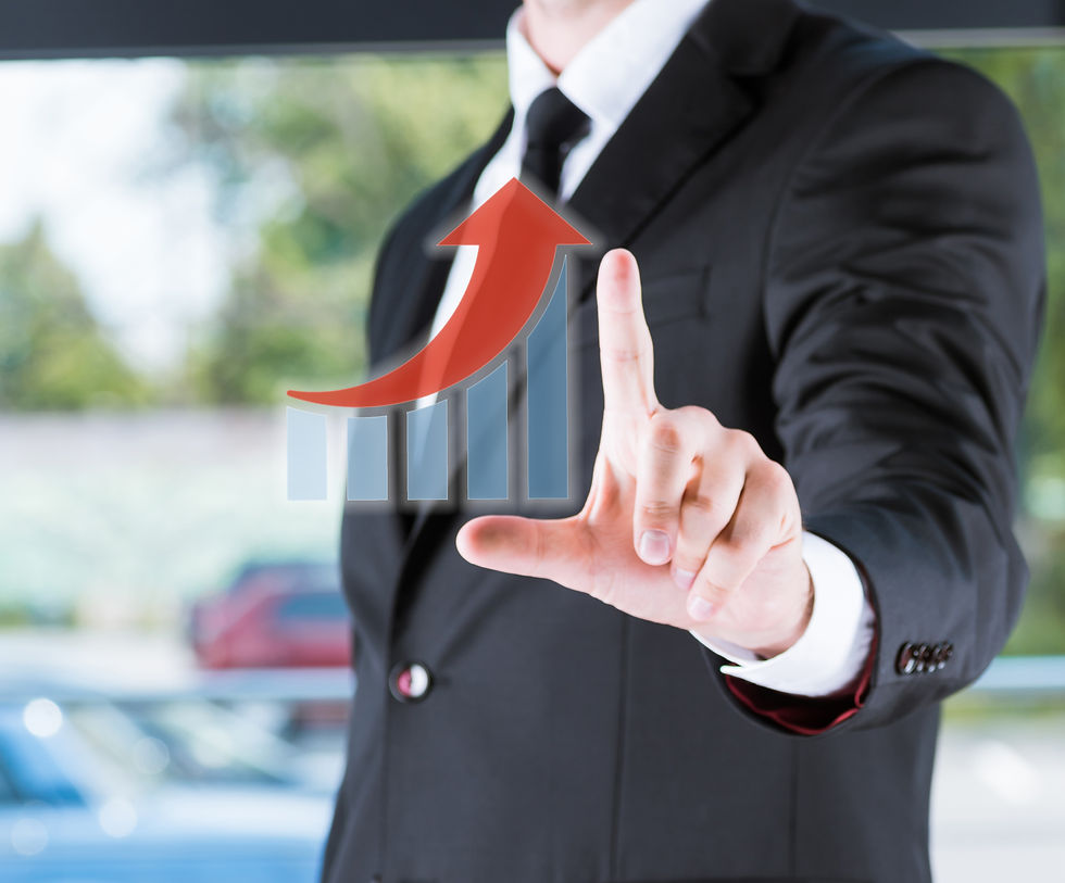 Businessman in suit touching virtual graph with rising red arrow representing growth and success.