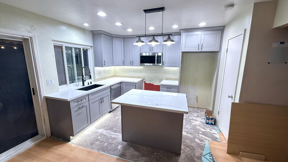 Modern kitchen lighting with recessed lights and pendant lights over the island