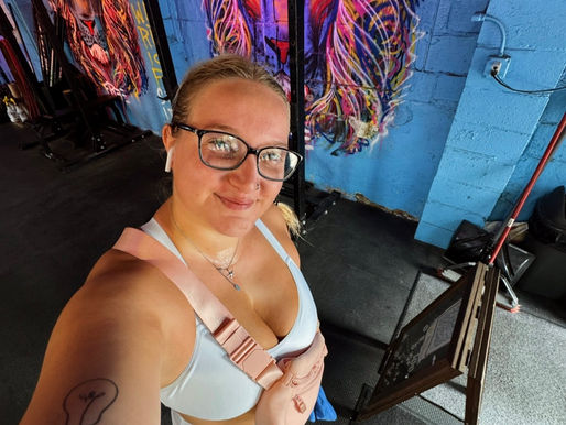 young woman taking selfie at gym post-workout