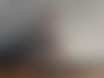 Blonde woman in her early 20's doing Warrior 1 yoga pose with pink ankle weights black mat