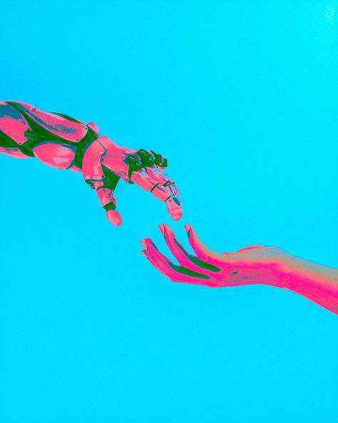 A robotic hand and a human hand reaching for each other against a solid bright blue background.