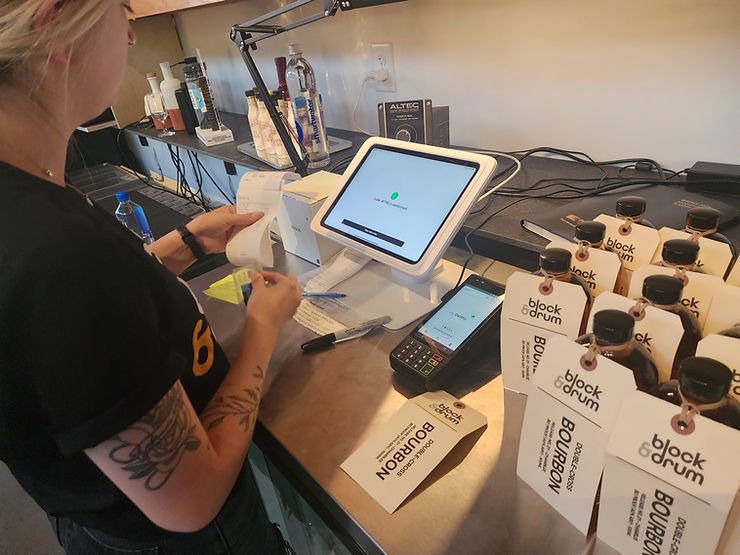 cashier handling a payment at a small business, ensuring secure and efficient payment processing for small business succes