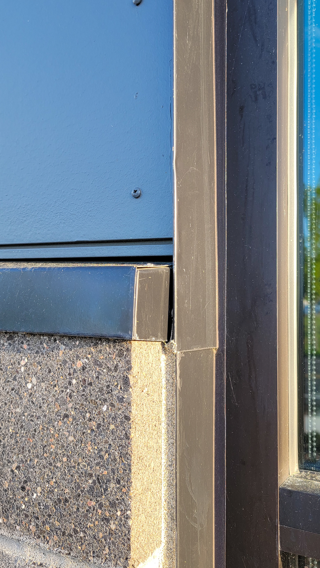 Close-up product photography of aluminum flashing stone caps inside detail. This important part of the building envelope is custom designed to promote maximum weatherization and drainage of Northwest Line Joint Accreditation Training Center. Commercial flashing & waterproofing by StraightLine Exteriors in Battle Ground, Washington 98604. 