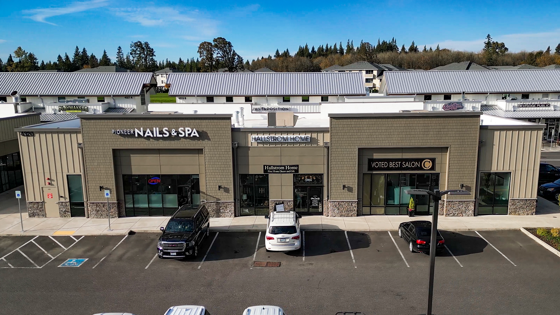Mid-morning aerial photo showing the western-style elevation of Building 9 after commercial siding installation by StraightLine Exteriors at Pioneer Village in Ridgefield, Washington 98642. 