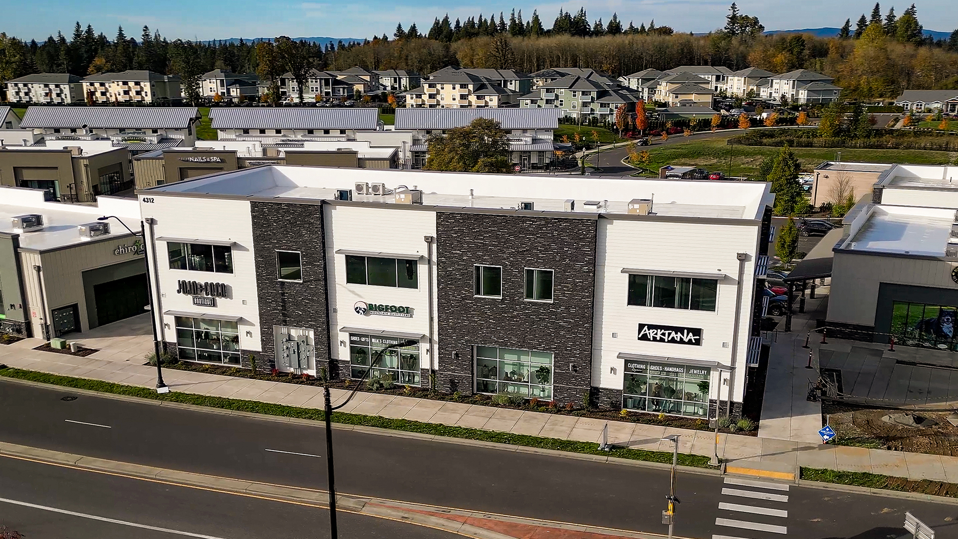 Mid-day aerial photo showing the exterior design of Building 3 after commercial siding installation by StraightLine Exteriors at Pioneer Village in Ridgefield, Washington 98642. Products include James Hardie® Fiber Cement : Hardie Plank Lap Siding and Hardie Soffit Panels.