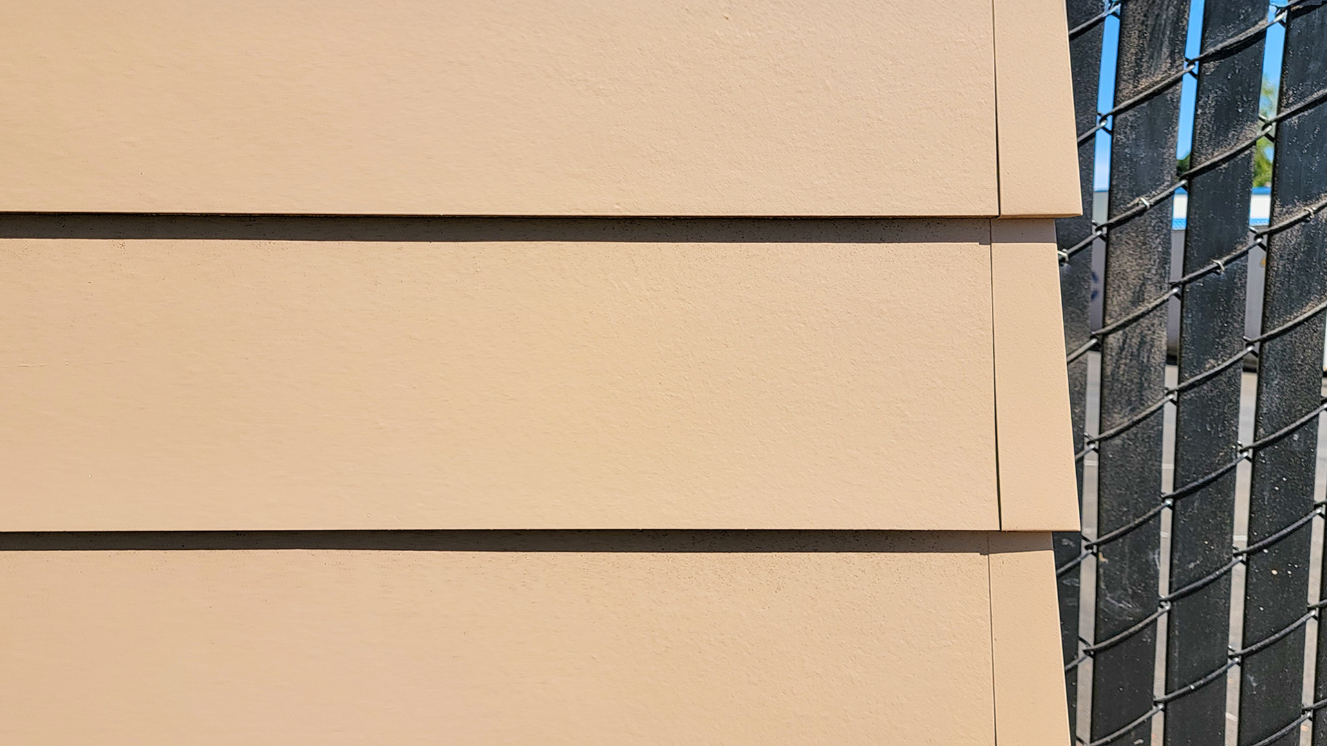 Hardieplank Lap Siding in Smooth product photo of Cascade Furniture & Mattress after commercial siding, soffit, post & beam installation by StraightLine Exteriors. 