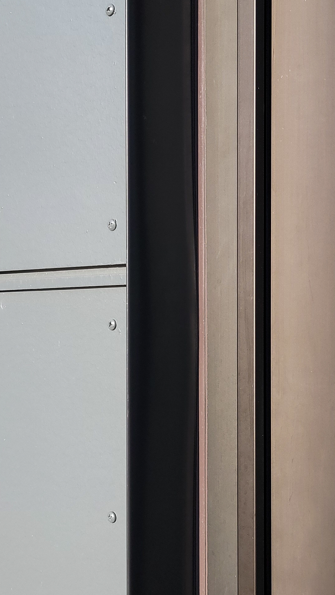 Close-up product photography of Tamlyn® XtremeTrim® in Black Anodized Aluminum inside detail. This important part of the building envelope is custom designed to promote maximum weatherization and drainage of Northwest Line Joint Accreditation Training Center. Commercial siding, flashing & waterproofing by StraightLine Exteriors in Battle Ground, Washington 98604. 
