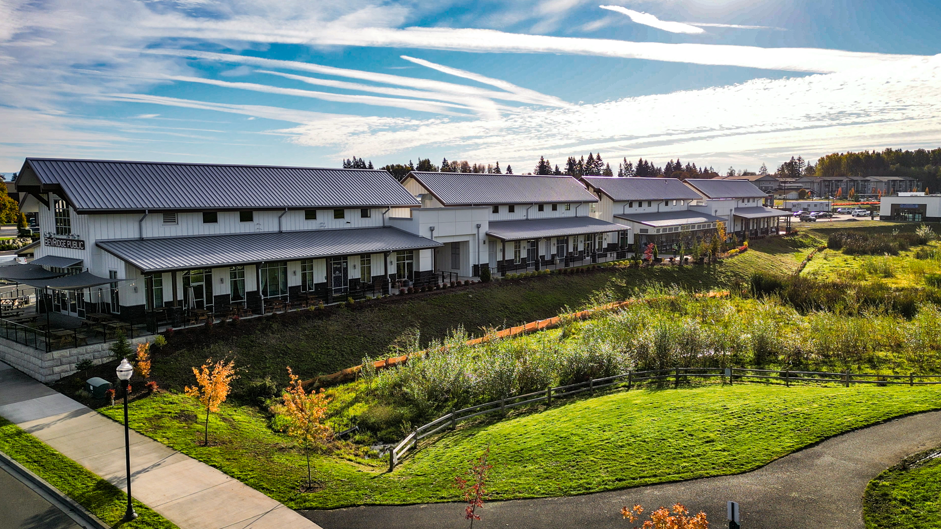 Mid-day photo showing the size, location & exterior design of Buildings 5-8 after commercial siding installation by StraightLine Exteriors at Pioneer Village in Ridgefield, Washington 98642.
