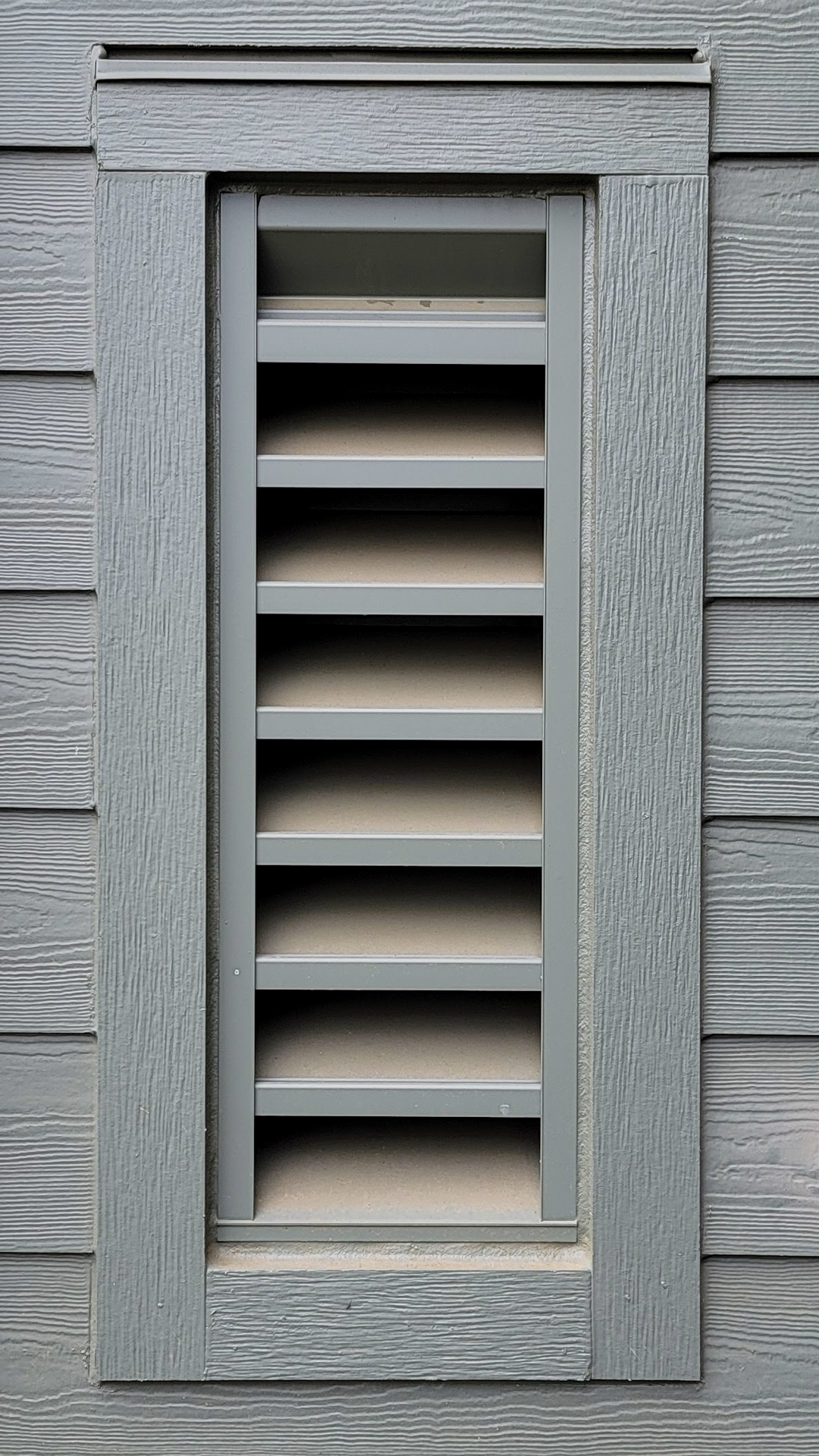 Close-up technical detail installation photography showing the vented penetration configuration and texture of James Hardie® Building Products Fiber Cement Hardie® Trim in Rustic. After commercial waterproofing, siding, window & soffit installation by StraightLine Exteriors in Beaverton, Oregon 97005. © StraightLine Exteriors 