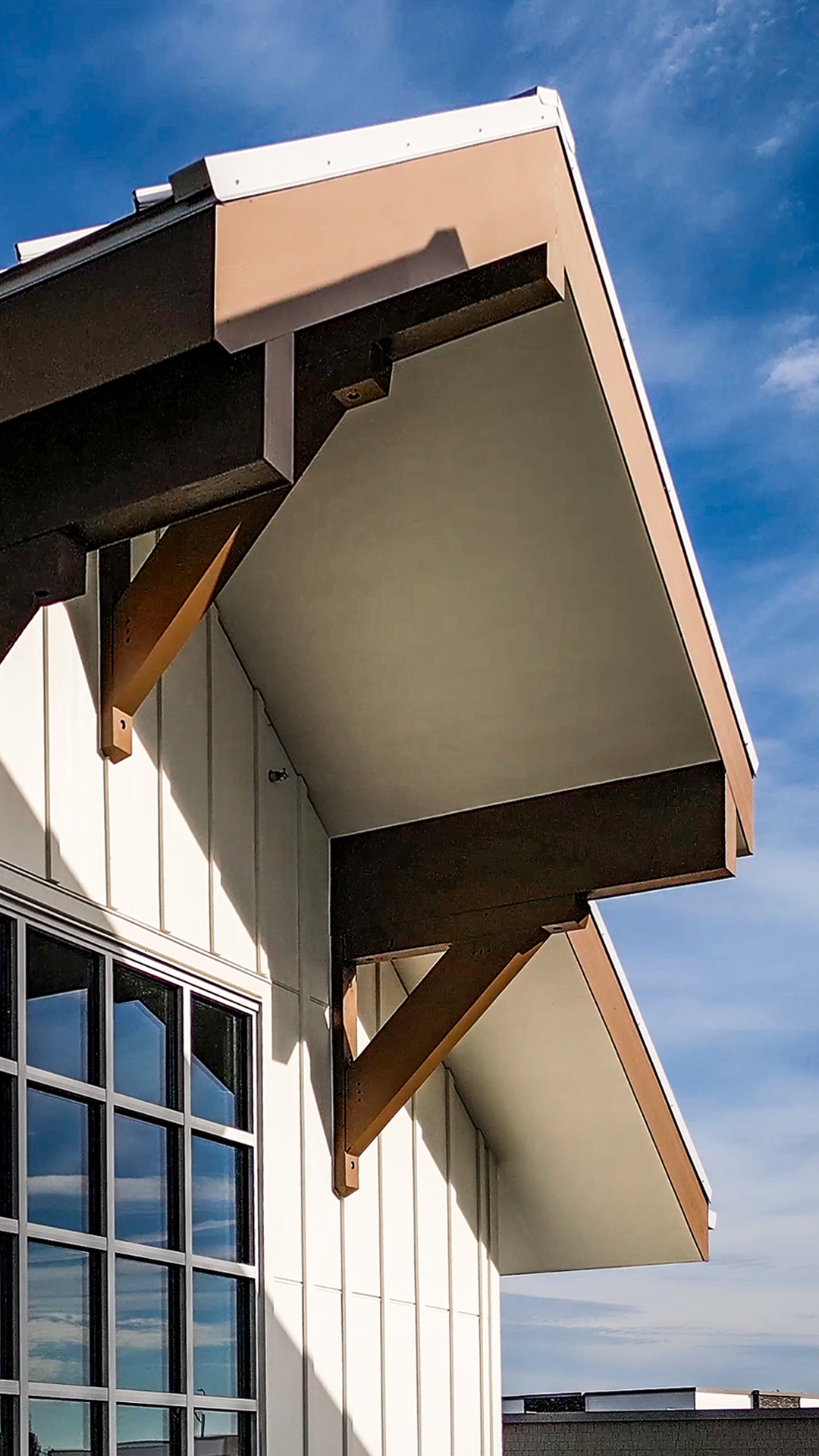 Mid day aerial photo showing the Barn-Inspired architectural details of Buildings 5-8 after  professional, commercial, property development siding installation by StraightLine Exteriors at Pioneer Village in Ridgefield, Washington 98642.