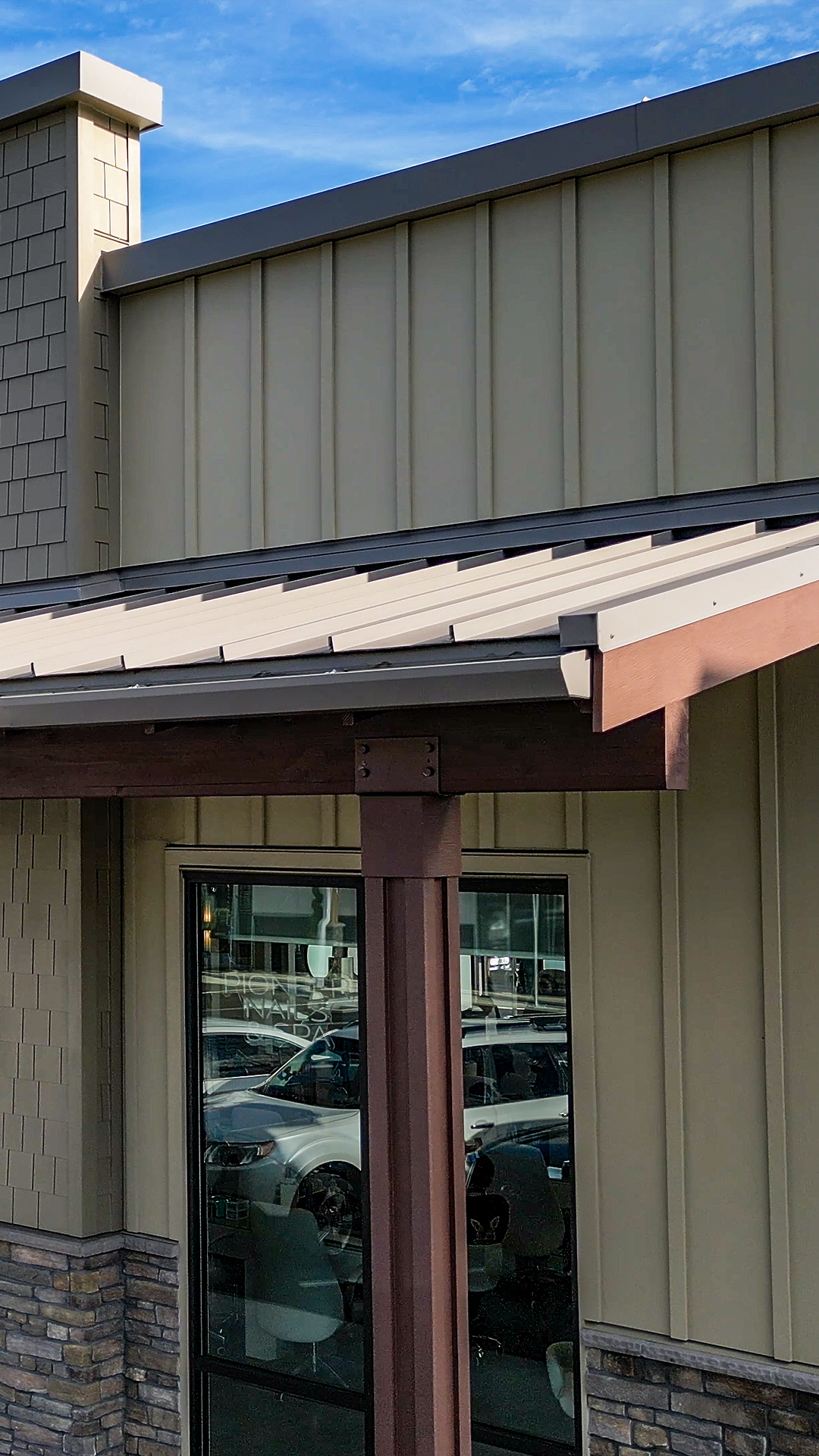 Early morning photo showing the front covered walkways, post, beam, roofing and siding of Building 9 after commercial siding installation by StraightLine Exteriors at Pioneer Village in Ridgefield, Washington 98642. 