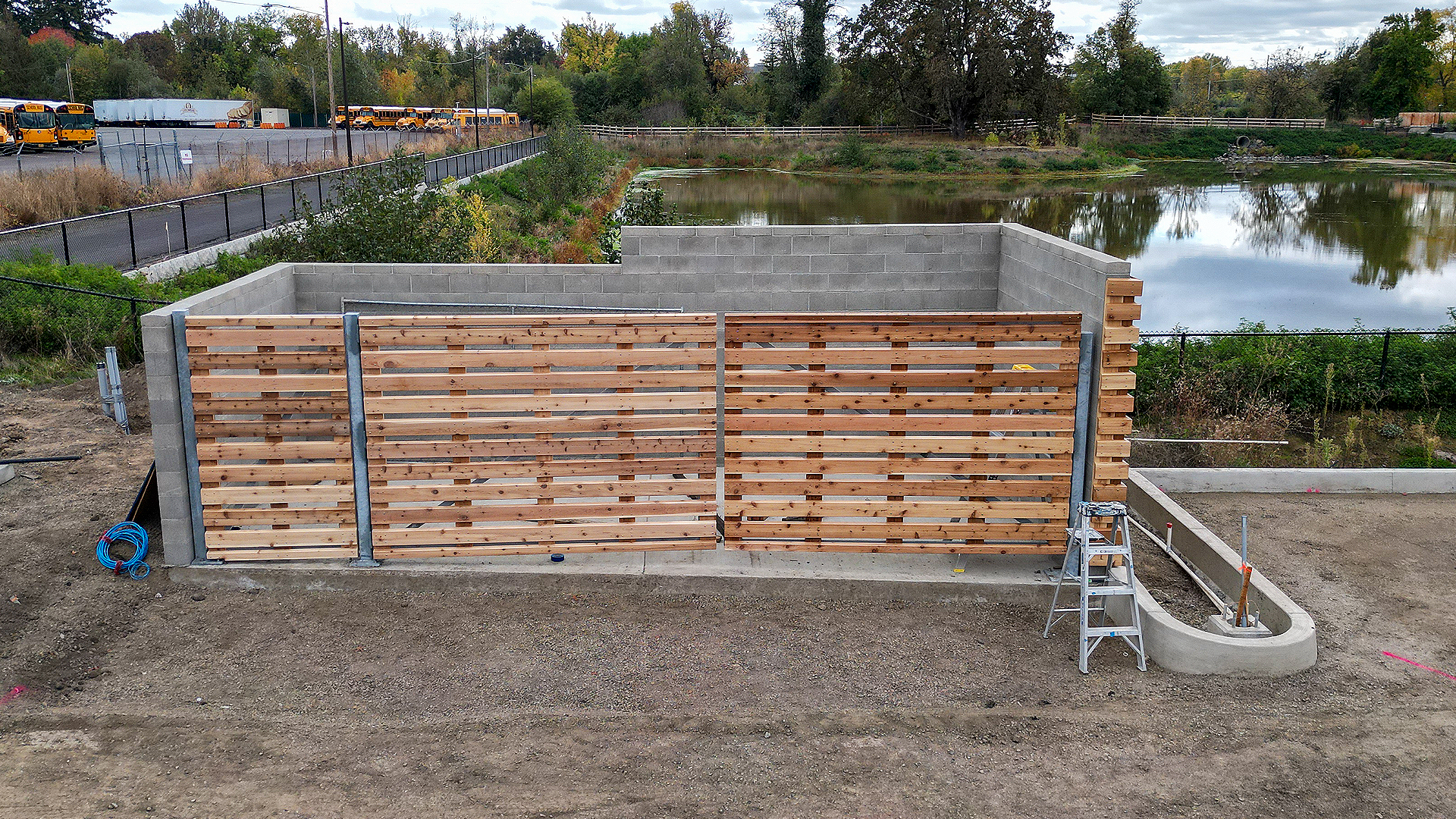 Mid-day aerial photography showing the color, configuration and texture of Stain Grade 2x6 Western Red Cedar in Tight Knot installed as a custom screen enclosure. After commercial waterproofing, siding, window & soffit installation by StraightLine Exteriors in Beaverton, Oregon 97005. © StraightLine Exteriors 