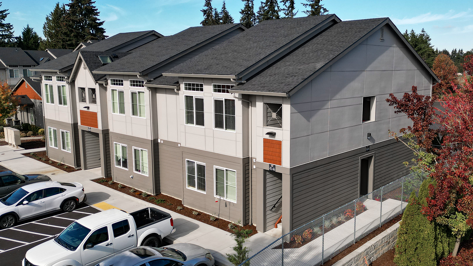 Mid-day aerial photo showing the contemporary exterior design of Wingate Square Apartments after commercial siding, soffit & window installation by StraightLine Exteriors in Vancouver, Washington 98662.
