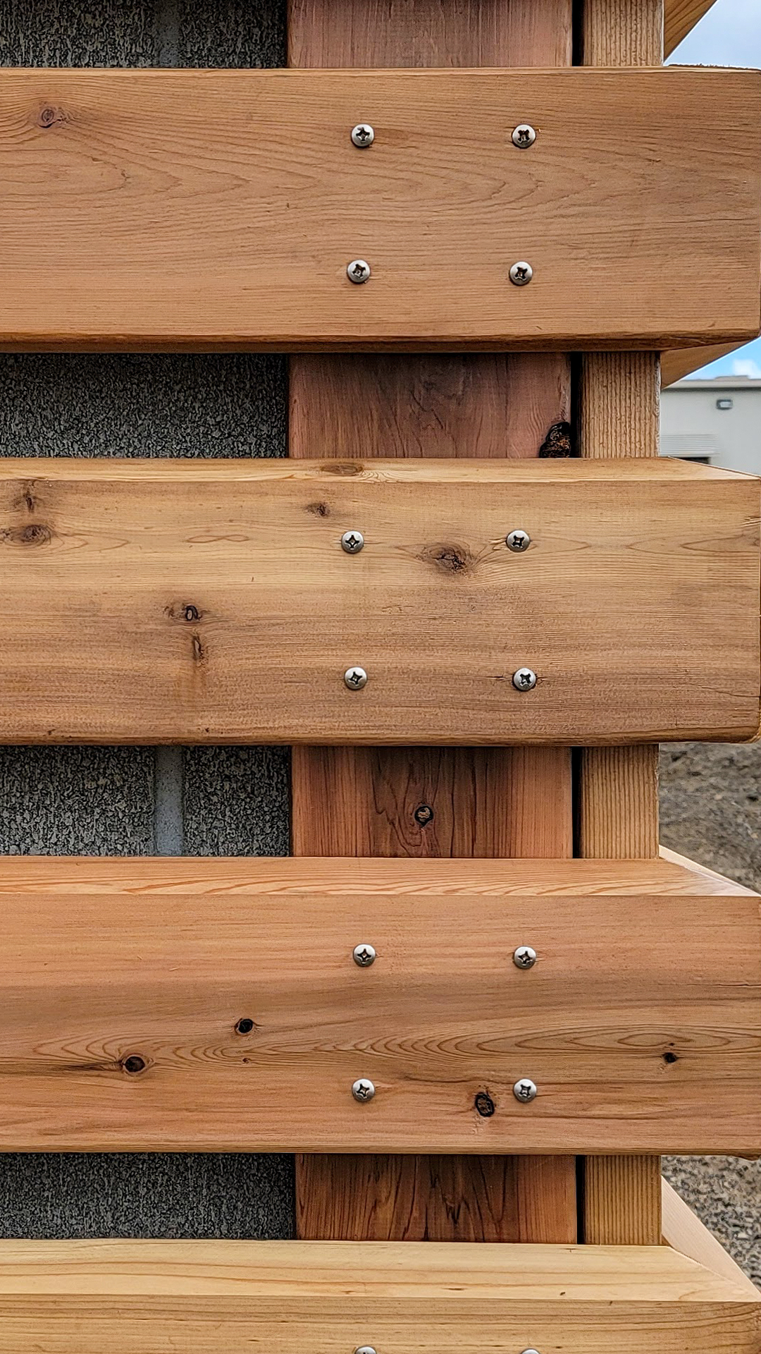 Close-up product photography showing the color, configuration and texture of Stain Grade 2x6 Western Red Cedar in Tight Knot. After commercial waterproofing, siding, window & soffit installation by StraightLine Exteriors in Beaverton, Oregon 97005. © StraightLine Exteriors 