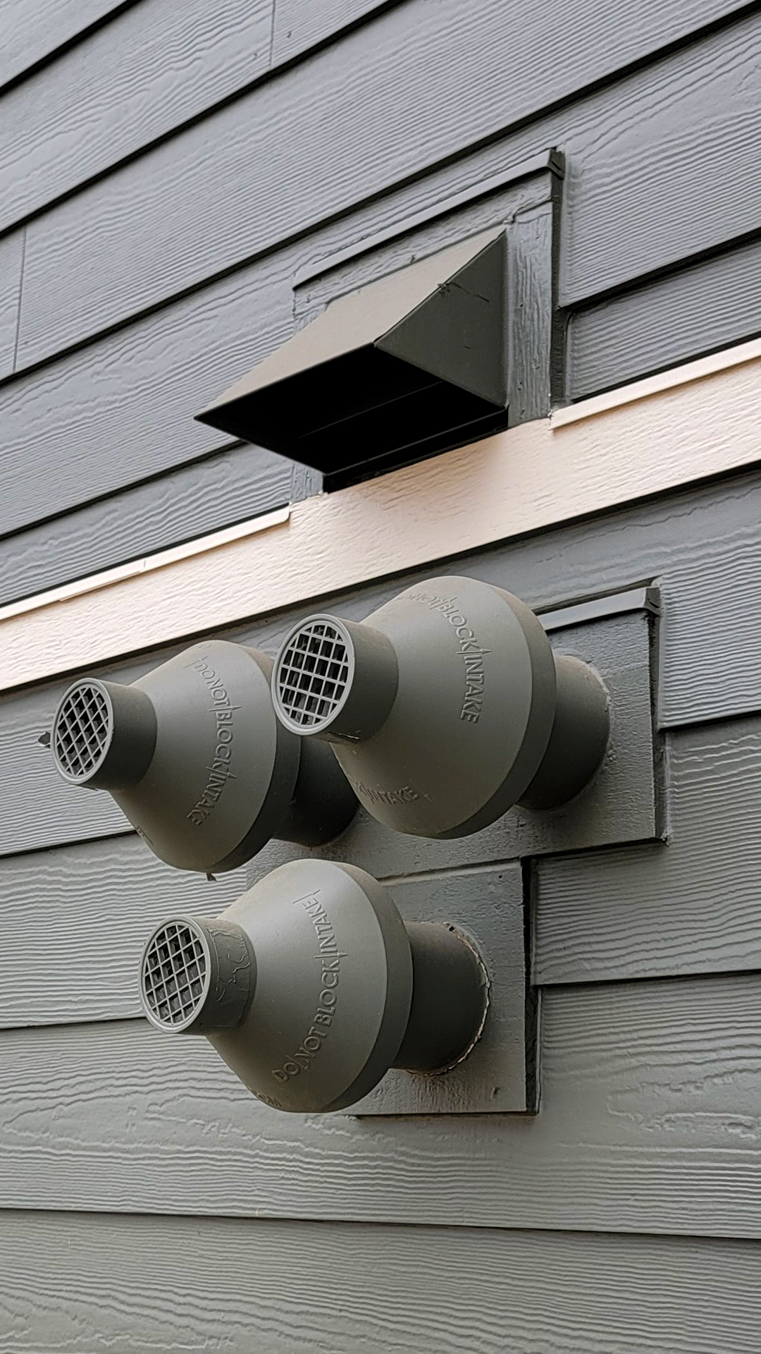 Close-up technical detail installation photography showing the vented penetration cluster configuration and James Hardie® Building Products Fiber Cement. After commercial waterproofing, siding, window & soffit installation by StraightLine Exteriors in Beaverton, Oregon 97005. © StraightLine Exteriors 