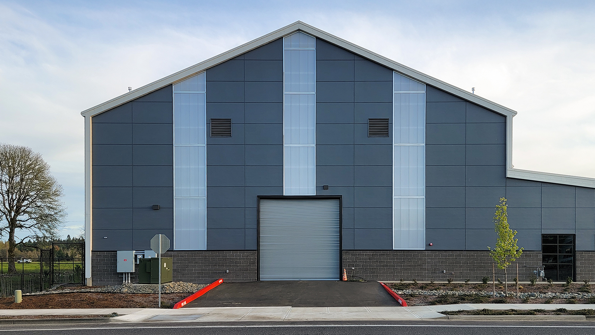 Dusk, ground-level, real estate photography showing the front industrial exterior elevation of the  NW Line JATC. Commercial siding installation of James Hardie fiber cement Siding & Soffits by StraightLine Exteriors in Battle Ground, Washington 98604. 