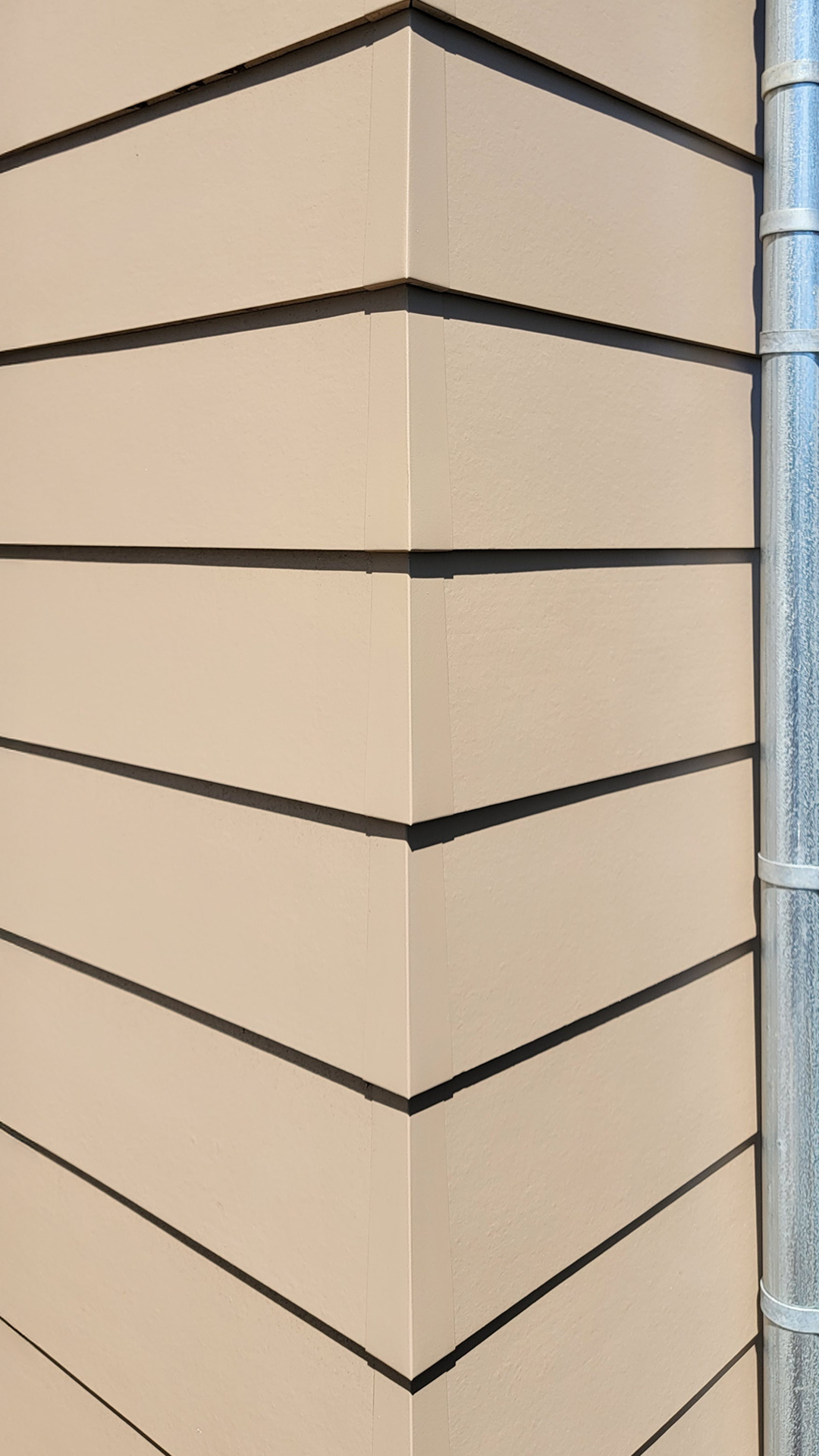 Hardieplank Lap Siding in Smooth : Aluminum Corner Cap product photo of Cascade Furniture & Mattress after commercial siding, soffit, post & beam installation by StraightLine Exteriors. 