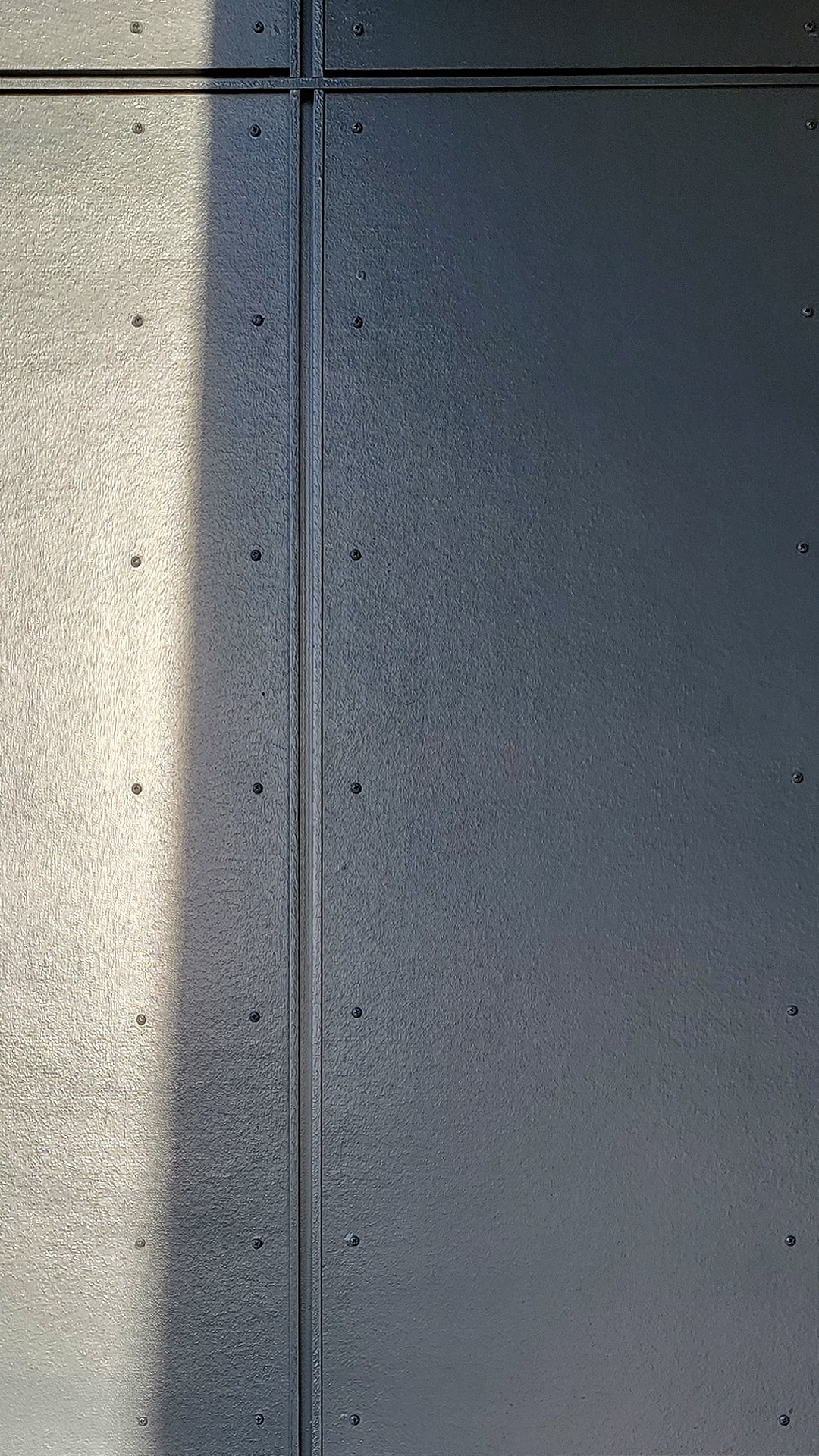 Product photography showing the James Hardie fiber cement siding product of Architectural Collection Panels in the texture Smooth installed using Tamlyn Architectural Trim & Channel and exposed fasteners. This product was installed at NW Line JATC by StraightLine Exteriors in Battle Ground, Washington 98604. 