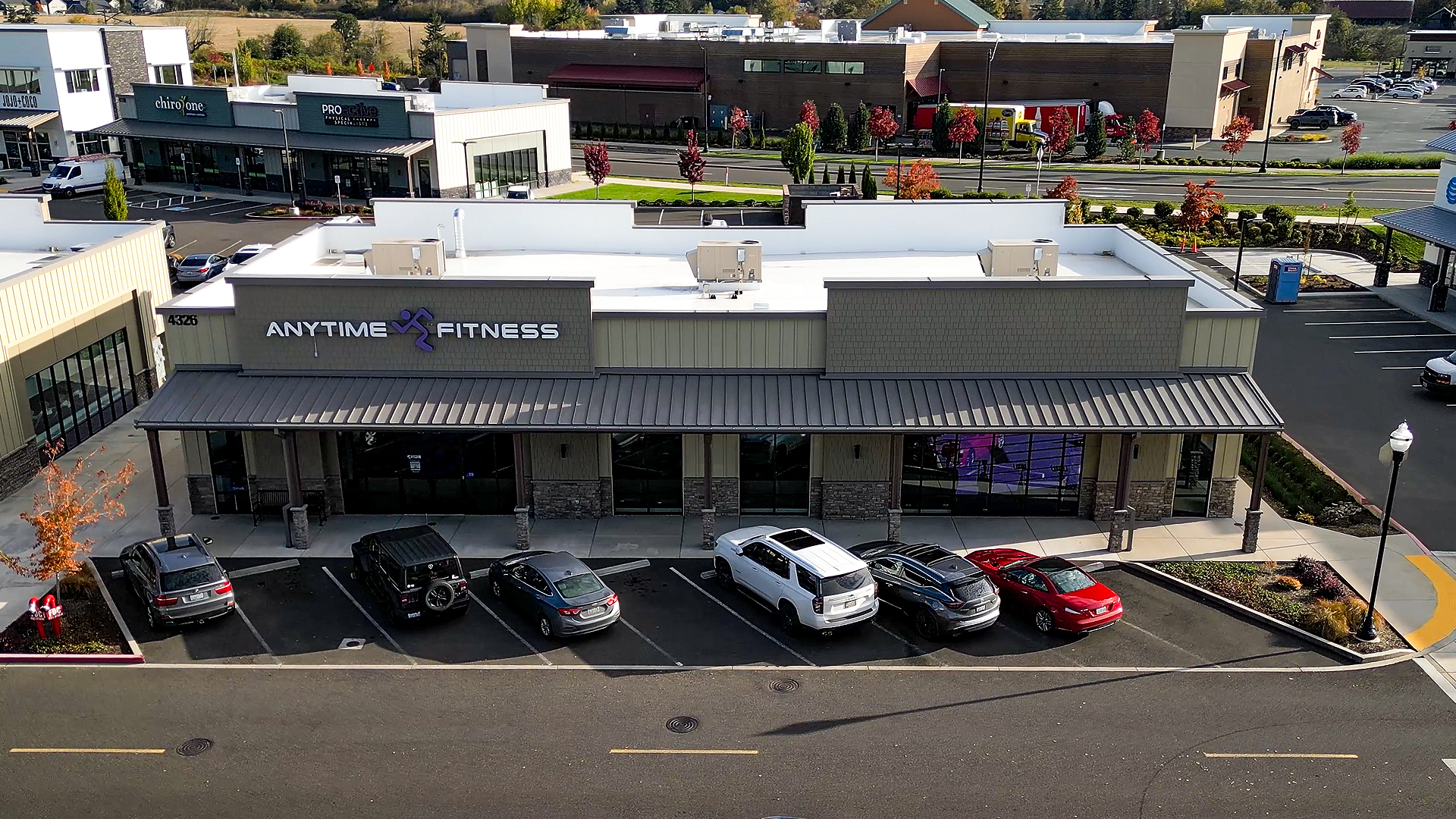 Early morning aerial photo showing the exterior design and western-style storefront of Building 10 after commercial siding installation by StraightLine Exteriors at Pioneer Village in Ridgefield, Washington 98642. 