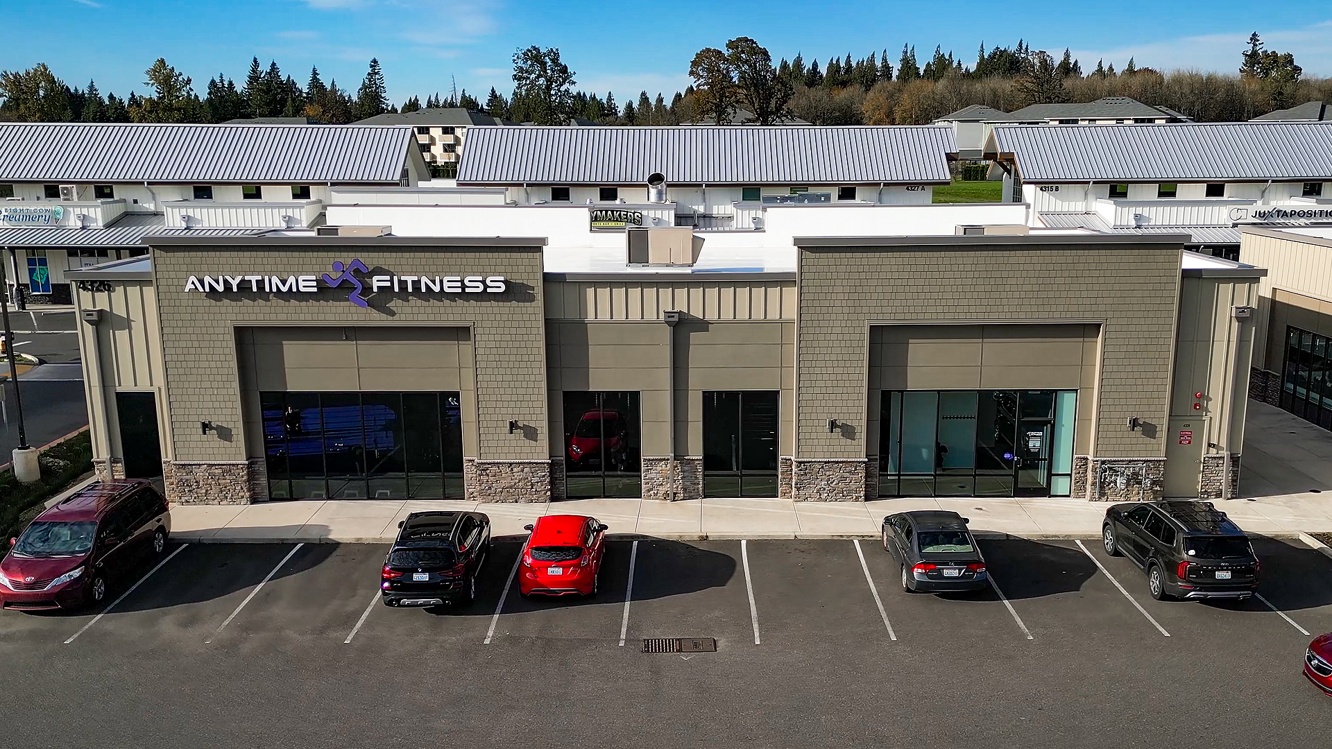 Mid-morning aerial photo showing the western-style elevation of Building 10 after commercial siding installation by StraightLine Exteriors at Pioneer Village in Ridgefield, Washington 98642. 