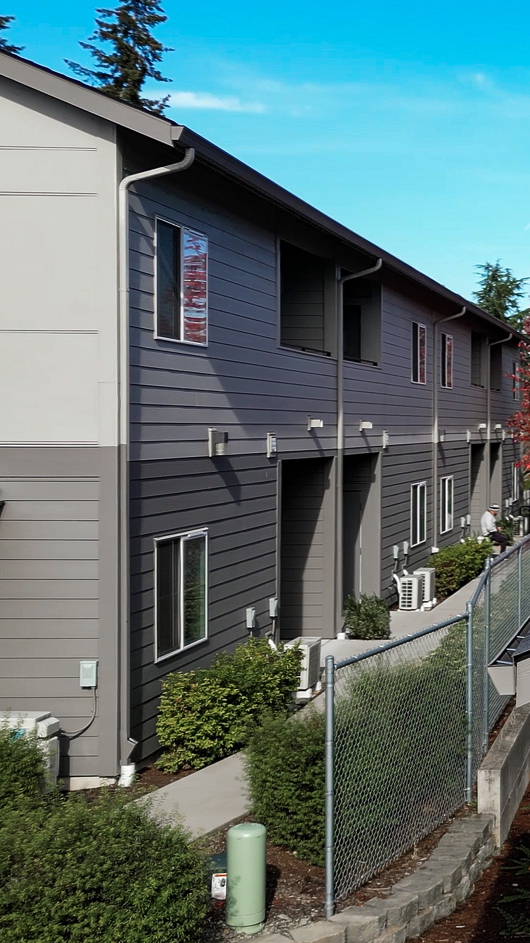 Mid-day aerial photo showing the rear outdoor living areas of Wingate Square Apartments after commercial siding, soffit & window installation by StraightLine Exteriors in Vancouver, Washington 98662.