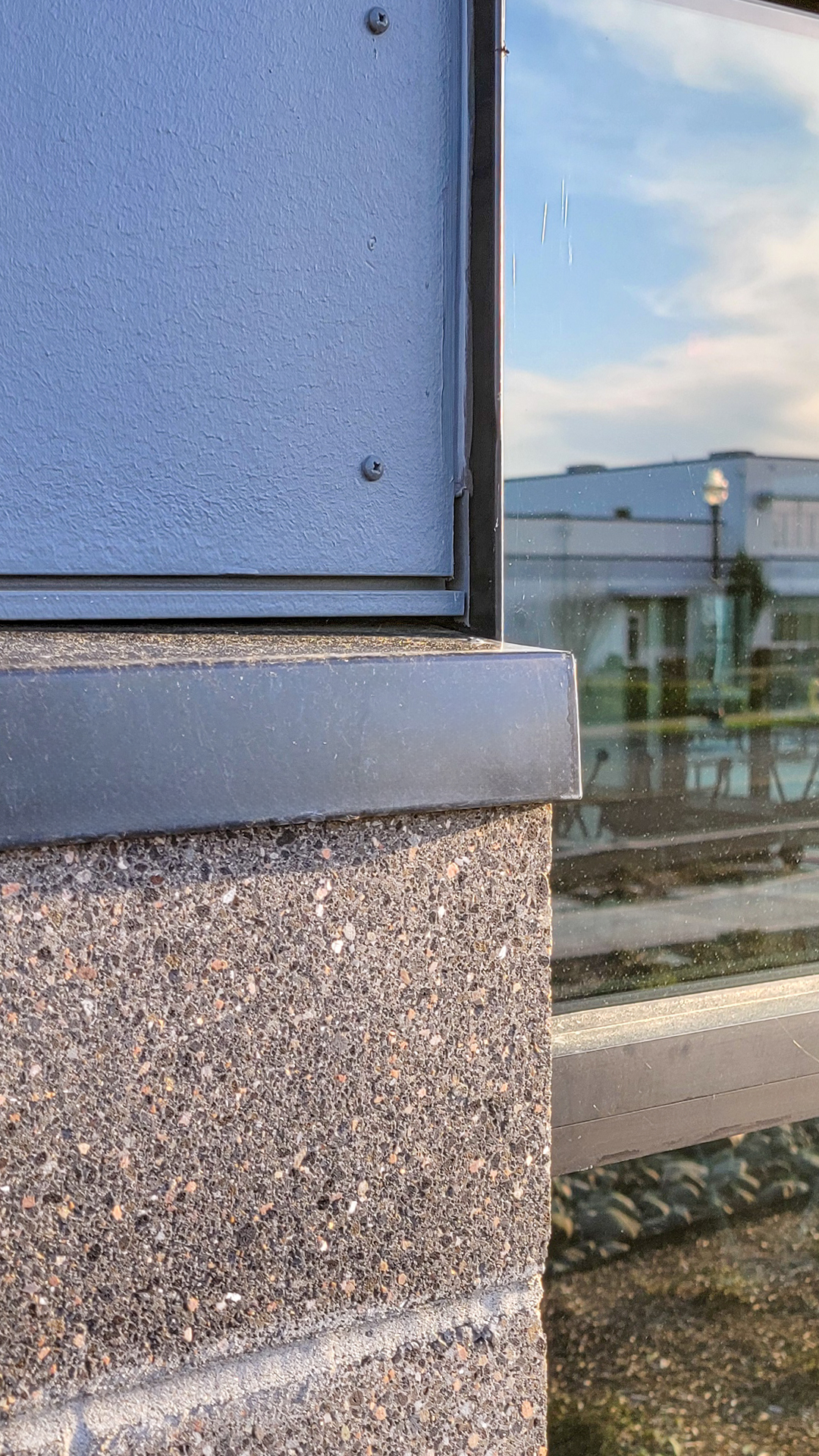 Close-up product photography of aluminum flashing stone caps outside detail. This important part of the building envelope is custom designed to promote maximum weatherization and drainage of Northwest Line Joint Accreditation Training Center. Commercial flashing & waterproofing by StraightLine Exteriors in Battle Ground, Washington 98604. 